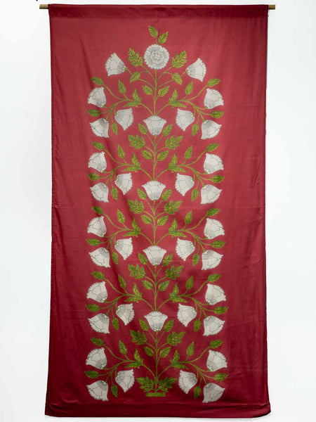 Red curtain with white floral patterns and green leaves on a white background