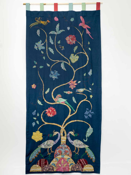 Decorative tapestry with peacocks, flowers, and birds on a blue background