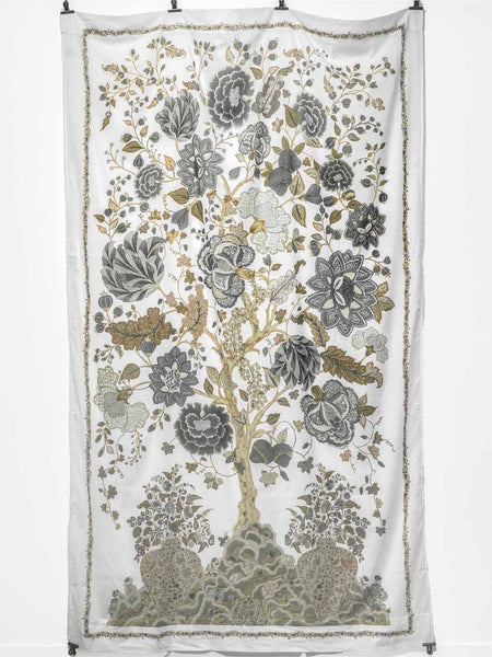 Floral and tree patterned curtain hanging on a rail