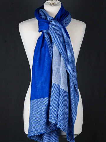 Blue checkered scarf on a mannequin against a black background