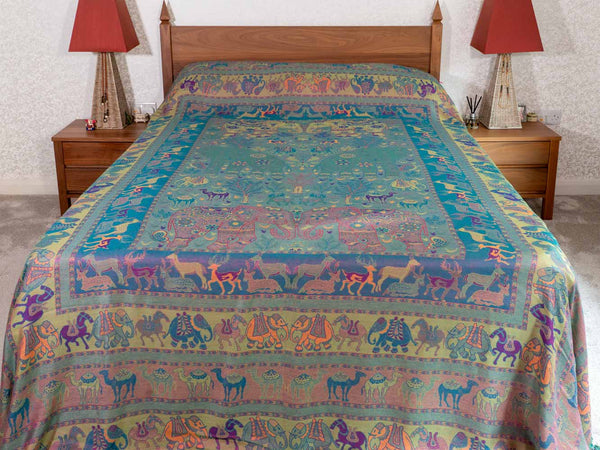 Bedspread with colorful animal pattern on a bed in a bedroom setting.