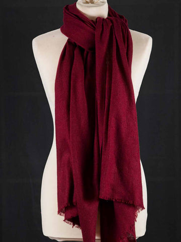 Red scarf on a mannequin against a black background