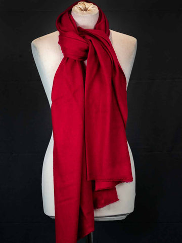 Red scarf on a mannequin against a black background