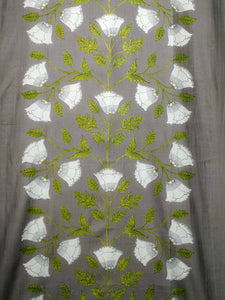 Embroidered cotton curtain with white floral patterns and green leaves on a gray background