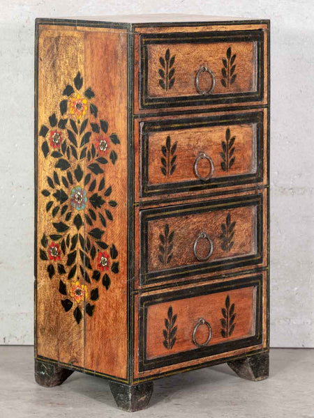 Wooden chest of drawers with floral patterns on a gray background