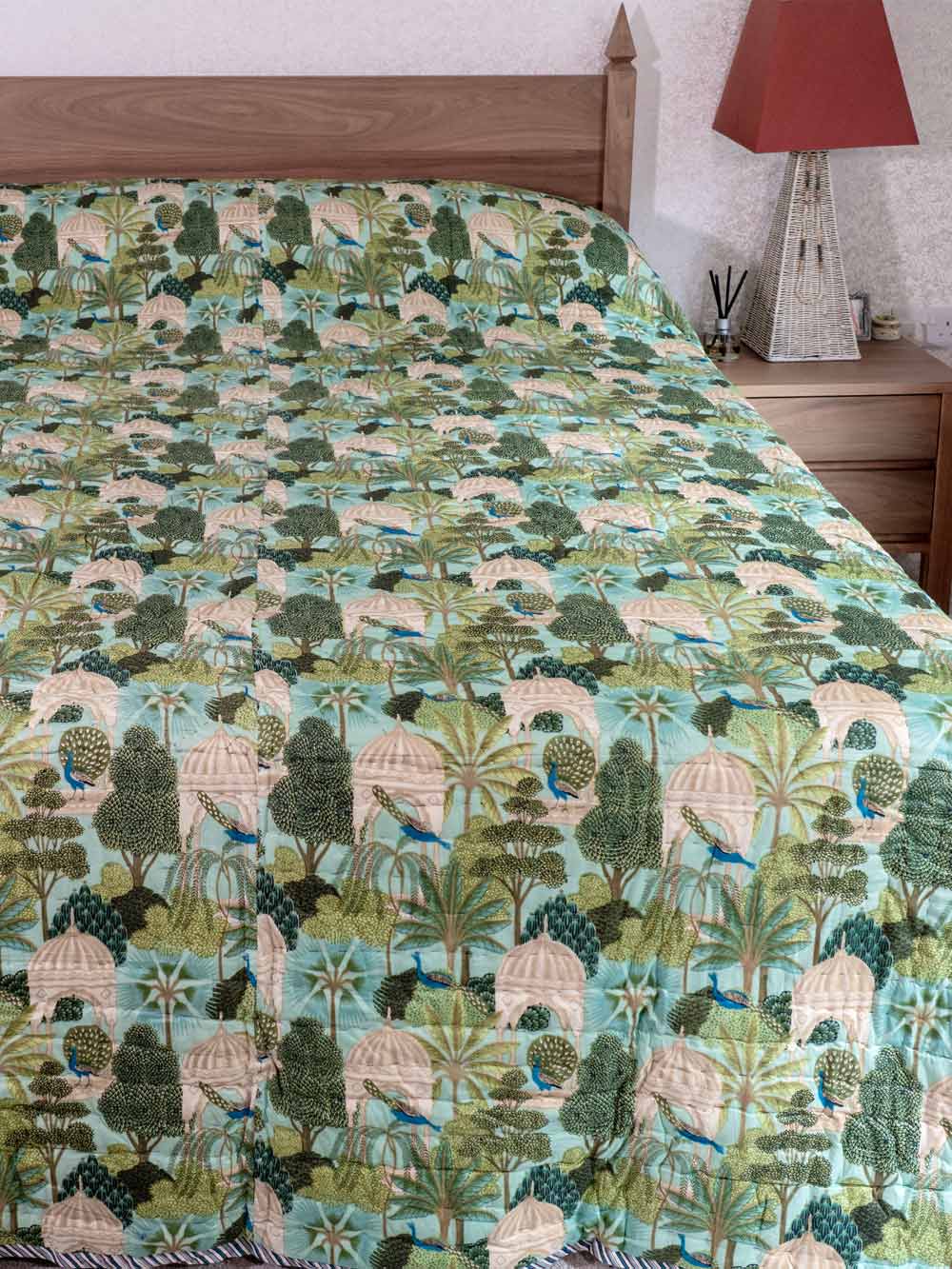 Bedspread with nature-themed design on a bed in a bedroom setting