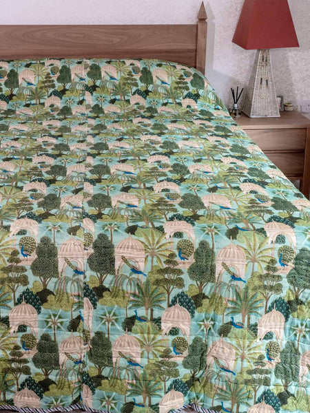 Bedspread with nature-themed design on a bed in a bedroom setting