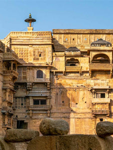 Indian architectural structure with intricate designs under a clear blue sky