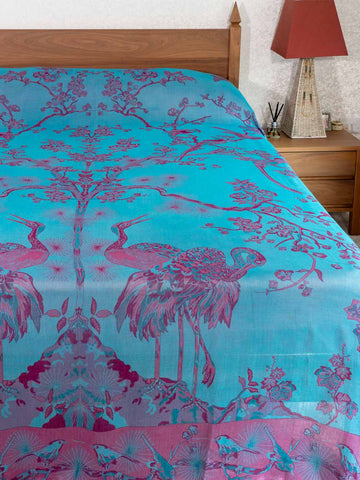 Turquoise and pink floral and bird patterned bedspread 