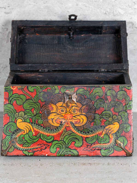 Decorative wooden box with colorful dragon design on a gray background