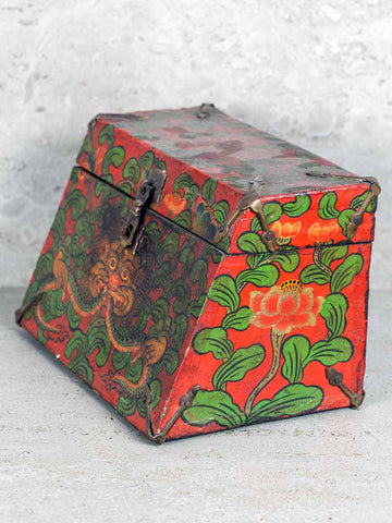 Decorative box with red and green floral patterns on a light gray background