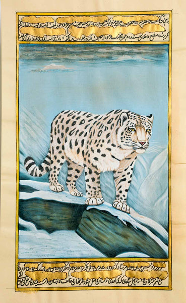 A framed-style artwork showing a spotted snow leopard standing on a snowy rocky ledge, with a blue icy background and decorative gold script bands at the top and bottom.