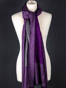 Purple scarf on a mannequin against a black background
