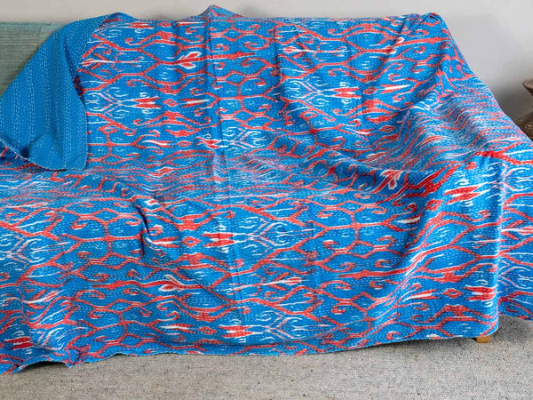 Blue and red patterned fabric on a bed