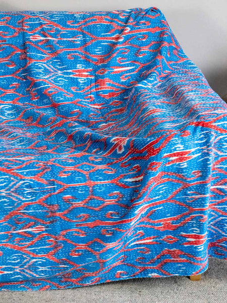 Blue and red patterned fabric on a gray surface