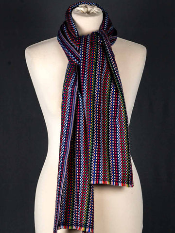 Colorful patterned scarf on a mannequin against a black background
