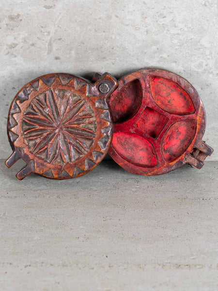 Decorative metal box with star pattern on a gray surface
