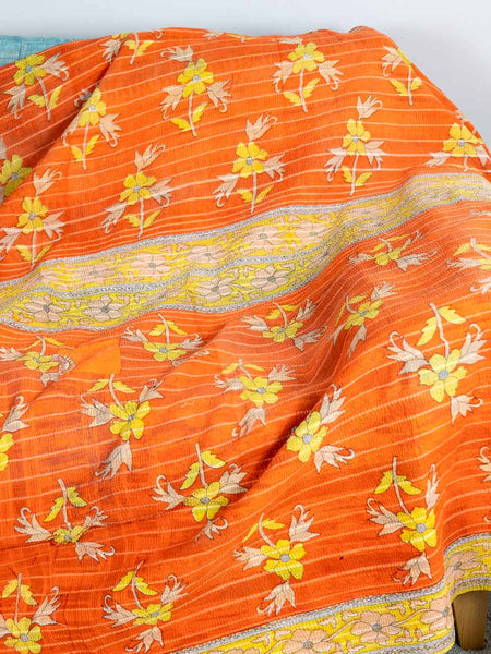 Orange fabric with floral patterns on a white background