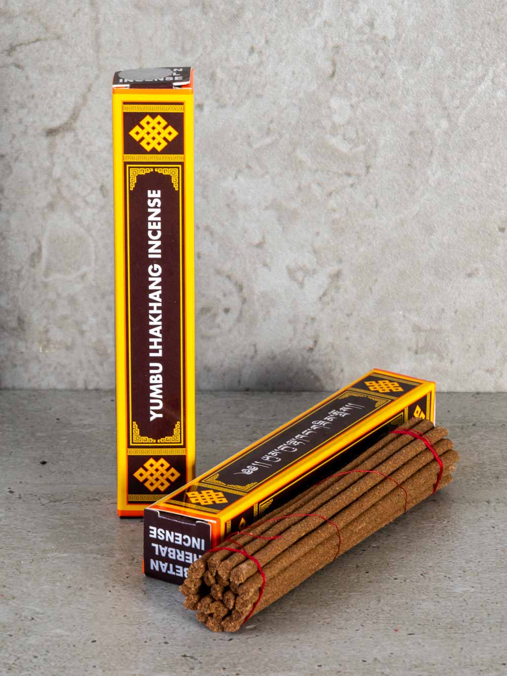 Yumbu Lhakhang incense sticks with packaging on a gray surface