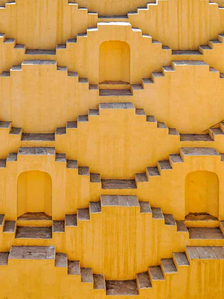 Yellow stepwell with geometric design in Jaipur, India